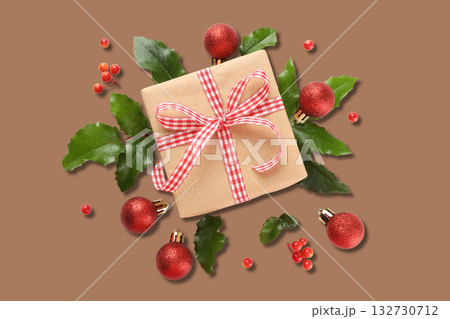 Gift box with ribbon among Christmas decor Gift box with ribbon among Christmas decor 132730712