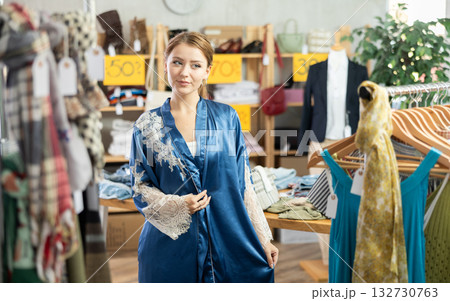 Woman trying on a silk robe Woman trying on a silk robe 132730763