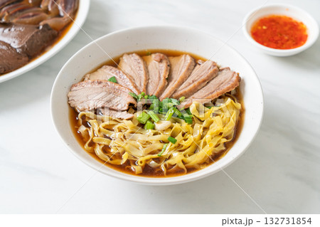 egg noodles with stewed duck in brown soup 132731854