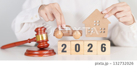 Happy New Year 2026 with house and Car model and gavel justice hammer on desk in courthouse. Real Estate and Car Law, Home Insurance, property Tax, Auction and Bidding concepts 132732026