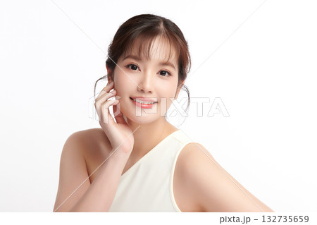 A beautiful young Asian woman with clean, fresh skin against a white background. Skincare, facial treatment, cosmetology, beauty, and spa. An elegant portrait of an Asian woman. 132735659