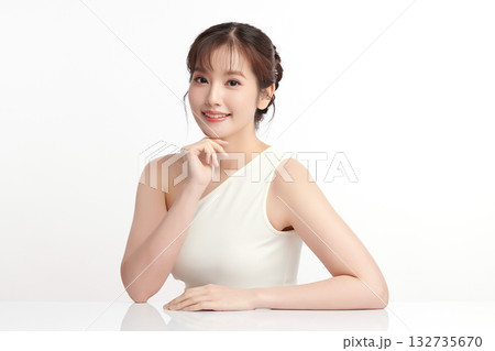 A beautiful young Asian woman with clean, fresh skin against a white background. Skincare, facial treatment, cosmetology, beauty, and spa. An elegant portrait of an Asian woman. A beautiful young Asian woman with clean, fresh skin against a white background. Skincare, facial treatment, cosmetology, beauty, and spa. An elegant portrait of an Asian woman. 132735670