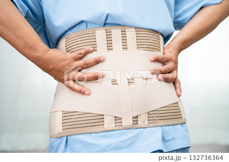 Asian lady patient wearing back pain support belt for orthopedic lumbar with walker. 132736364
