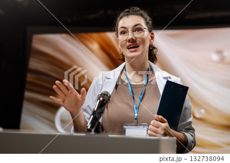 woman is giving a presentation at a conference 132738094