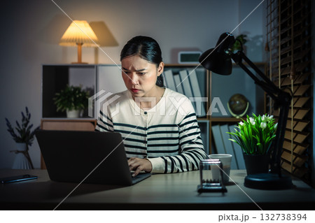 stressed woman working with laptop at night stressed woman working with laptop at night 132738394