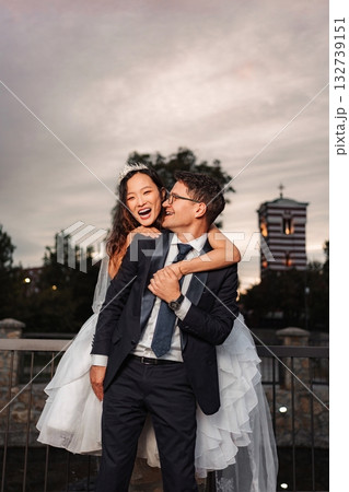 Happy interracial couple enjoying wedding day outdoors Happy interracial couple enjoying wedding day outdoors 132739151