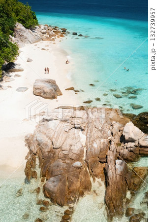 A beautiful tropical beach on the island of Lang Tengah in Malaysia with clear turquoise water and large stones on a sunny day A beautiful tropical beach on the island of Lang Tengah in Malaysia with clear turquoise water and large stones on a sunny day 132739957