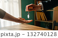 Real estate agent gives house keys to new homeowner 132740128