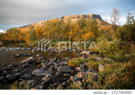 Lake shore with autumn trees and Saana mountain in Kilpisjarvi Finland Lake shore with autumn trees and Saana mountain in Kilpisjarvi Finland 132740980