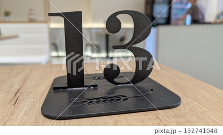 Elevate your establishment with the Stylish Table Number 13, perfect for Restaurants or Cafes 132741048