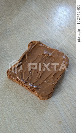 Indulge in the Delight of Spreading Creamy Peanut Butter Generously on Crispy Toast 132741409