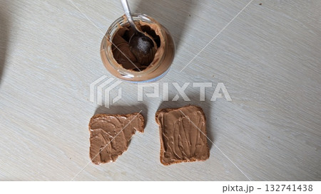 A delicious and creamy peanut butter spread generously applied on fresh slices of bread 132741438