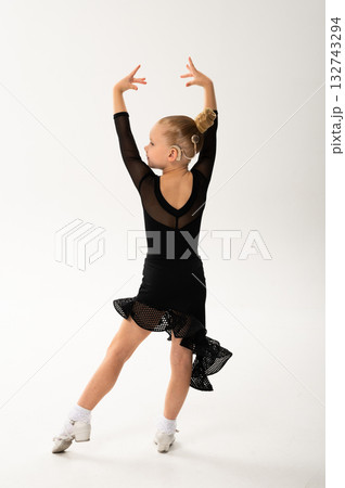 Smiling child in black ballroom outfit practicing elegant movement with hearing technology cochlear implant. Strength, inclusion, and artistic discipline harmonize to celebrate diversity and human Smiling child in black ballroom outfit practicing elegant movement with hearing technology cochlear implant. Strength, inclusion, and artistic discipline harmonize to celebrate diversity and human 132743294