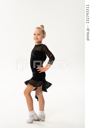 Smiling child in black ballroom outfit practicing elegant movement with hearing technology cochlear implant. Strength, inclusion, and artistic discipline harmonize to celebrate diversity and human Smiling child in black ballroom outfit practicing elegant movement with hearing technology cochlear implant. Strength, inclusion, and artistic discipline harmonize to celebrate diversity and human 132743311