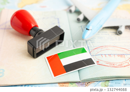 UAE United Arab Emirates flag with passport and airplane for travel. UAE United Arab Emirates flag with passport and airplane for travel. 132744088