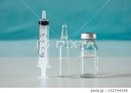 medical syringe, ampoule and flacon on table medical syringe, ampoule and flacon on table 132744348
