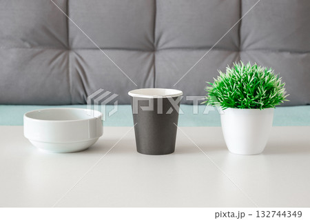 bowl paper cup and decorative flower on table bowl paper cup and decorative flower on table 132744349