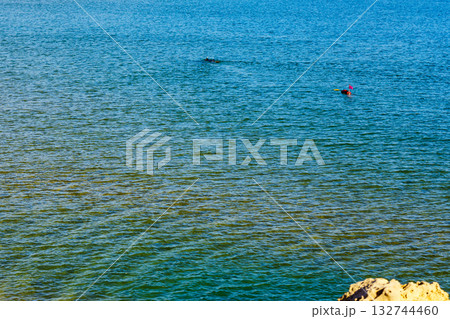 Person scuba diver with equipment diving in blue water 132744460