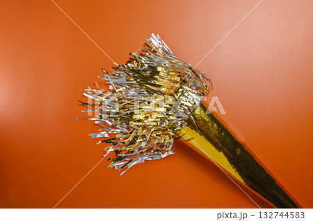 Party horn on a red background. Concept of a party or a holiday celebration Party horn on a red background. Concept of a party or a holiday celebration 132744583