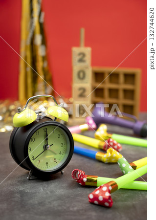 Stack of wooden cubes with the number 2026 with an alarm clock, plastic horn, and party blowers. Happy New Year concept or Celebration Stack of wooden cubes with the number 2026 with an alarm clock, plastic horn, and party blowers. Happy New Year concept or Celebration 132744620
