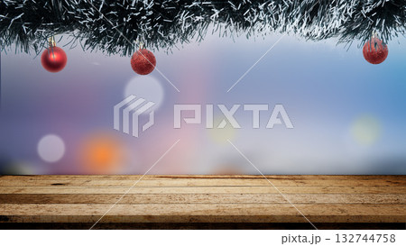 Christmas ornaments hanging above the table with a blurred bokeh light background. Copy space. Holiday greetings or winter themes. Concept of the Merry Christmas celebration 132744758