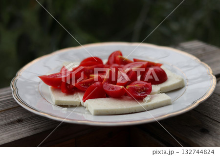 Traditional sheep cheese with tomatoes. Traditional sheep cheese with tomatoes. 132744824