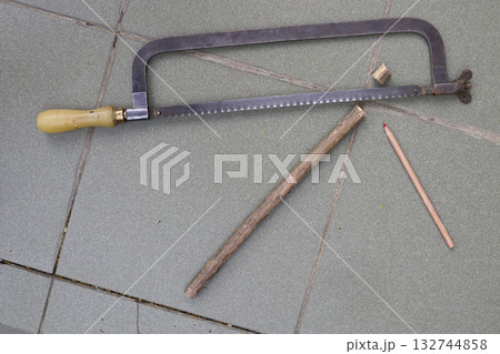 Still life with a saw and pencil. 132744858