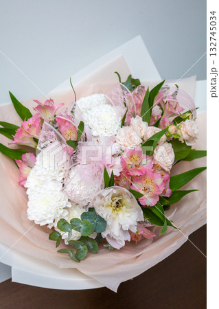 Large beautiful bouquet of mixed flowers in woman hand. Floral shop concept . Handsome fresh bouquet. Flowers delivery Large beautiful bouquet of mixed flowers in woman hand. Floral shop concept . Handsome fresh bouquet. Flowers delivery 132745034
