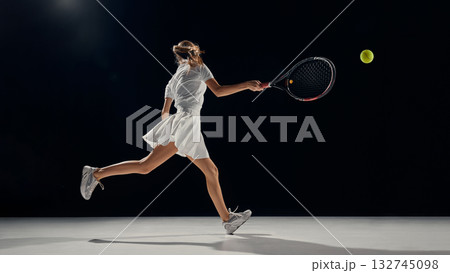 Young female athlete returning tennis ball in dynamic fast motion Young female athlete returning tennis ball in dynamic fast motion 132745098