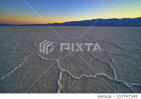 Cracked Salt Flats Badwater Basin at Sunset with Distant Mountains Golden Hour Cracked Salt Flats Badwater Basin at Sunset with Distant Mountains Golden Hour 132747248