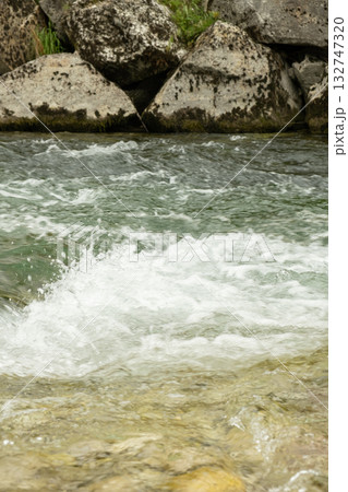 Scenic Mountain Stream with Clear Water and Rocky Banks Scenic Mountain Stream with Clear Water and Rocky Banks 132747320