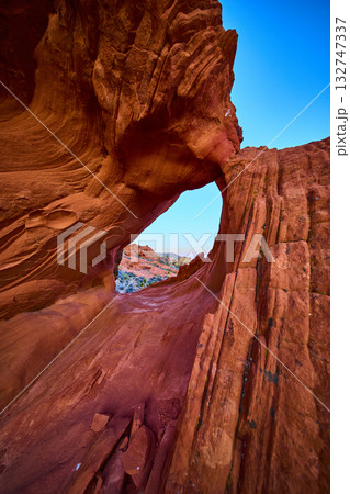 Red Rock Arch Formation and Desert Landscape Under Blue Sky Red Rock Arch Formation and Desert Landscape Under Blue Sky 132747337