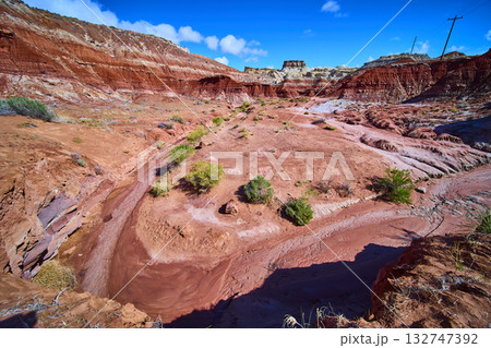 Red Rock Formations and Dry Wash in Utah Desert Under Blue Sky 132747392