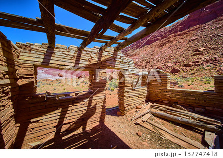 Abandoned Stone Ruins and Collapsed Roof Beams in Utah Desert Canyon Sunlight 132747418