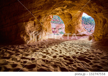 Sandstone Cave Interior with Sunlit Desert Landscape Kanab Utah Sandstone Cave Interior with Sunlit Desert Landscape Kanab Utah 132747558