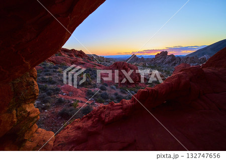 Red Rock Arch and Sunset Over Desert Landscape 132747656