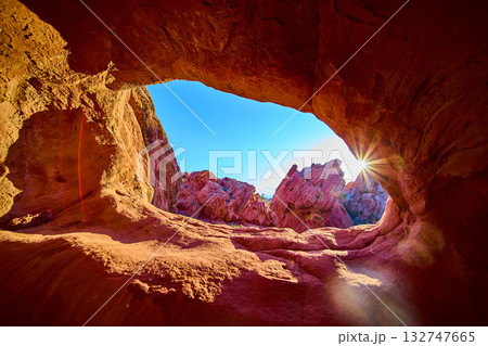 Sunburst Through Red Rock Arch at Golden Hour in Scenic Desert Landscape Sunburst Through Red Rock Arch at Golden Hour in Scenic Desert Landscape 132747665