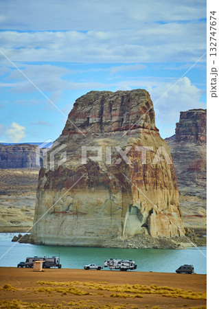 Lone Rock Sandstone Formation and RV Camping by Lake Powell under Blue Sky Lone Rock Sandstone Formation and RV Camping by Lake Powell under Blue Sky 132747674