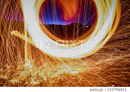 Steel Wool Sparks Swirling Over Desert Ground at Golden Hour in Nevada Steel Wool Sparks Swirling Over Desert Ground at Golden Hour in Nevada 132748021