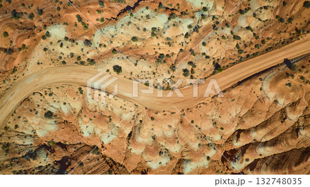 Aerial Top Down Desert Road Winding Through Colorful Rock Formations Utah Aerial Top Down Desert Road Winding Through Colorful Rock Formations Utah 132748035