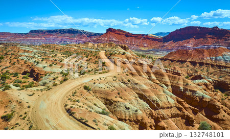 Aerial Desert Road Winding Through Multicolored Sandstone Hills Utah 132748101
