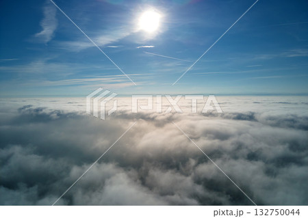 Aerial view from high altitude of earth covered with puffy rainy clouds forming before rainstorm 132750044