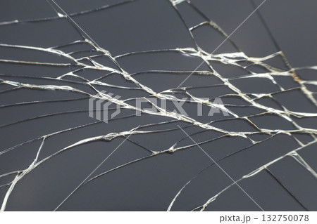 Abstract pattern dark gray background. Crackled screen of mobile cellphone. Gadget repair and maintenance concept. 132750078