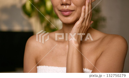 Closeup of female face with water drops showing freshness and glow Closeup of female face with water drops showing freshness and glow 132750279