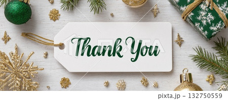 paper tag with words thank you on christmas background with green and golden decoration 132750559