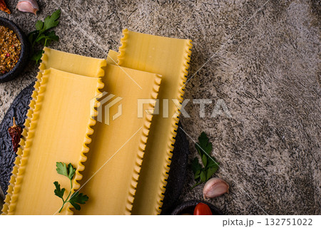 Uncooked lasagna pasta with cooking ingredient Uncooked lasagna pasta with cooking ingredient 132751022