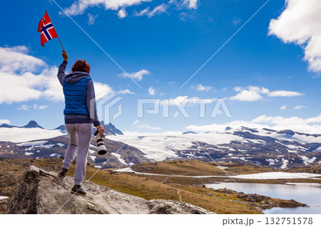 Tourist with camera and flag in Norway mountains 132751578
