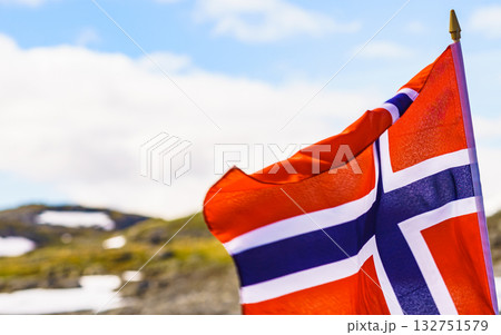 Norwegian flag and mountains snowy landscape Norwegian flag and mountains snowy landscape 132751579