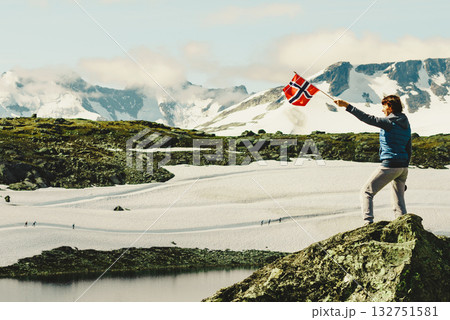 Tourist with norwegian flag in mountains Tourist with norwegian flag in mountains 132751581