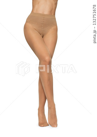Beautiful long fit female legs in beige tights on white background 132751678
